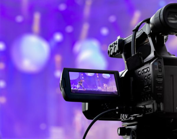 Video production covering event on stage by professional video camera